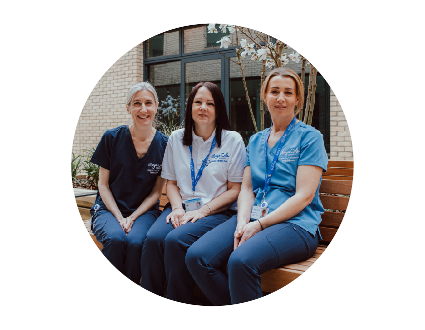 Three hospice staff members sitting together on a bench